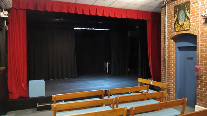 An empty stage at the Artists of Artem County's warehouse.